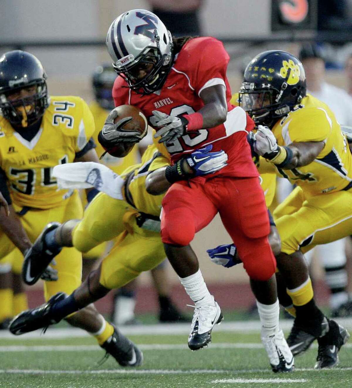 9/23/11: Running back Selwyn Green #29 of the Manvel Mavericks rushes against defensive back Myles Drisdale #6 of the La Marque Cougars in the opening of District 24-4A high school football game at Alvin Memorial Stadium in Alvin, Texas. For the Chronicle: Thomas B. Shea