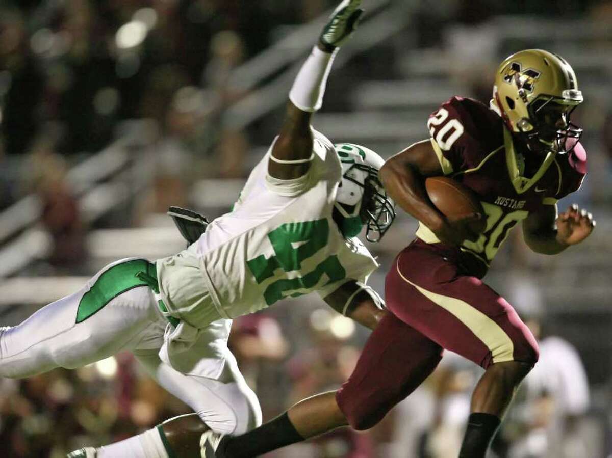 Magnolia West's Desmond Richards (20) runs past the reach of Brenham's Jerid Jeter-Gilman for a 40-yard reception during the first quarter of their game, Friday at Mustang Stadium in Magnolia.