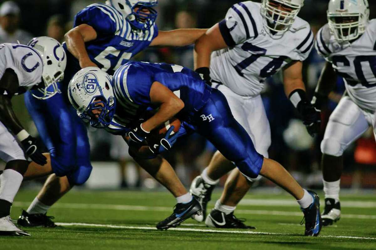 NATHAN LINDSTROM: FOR THE CHRONICLE HEADING IN THE RIGHT DIRECTION: Barbers Hill fullback Clay McDonald, center, leans forward for some extra yardage during Friday night's victory over Dayton.