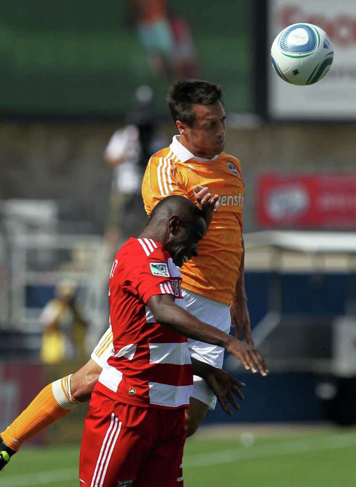 Dynamo 1, FC Dallas 0: Jair Benitez #5 of FC Dallas jumps for the header with Danny Cruz #5 of the Houston Dynamo at Pizza Hut Park on September 24, 2011 in Frisco, Texas.