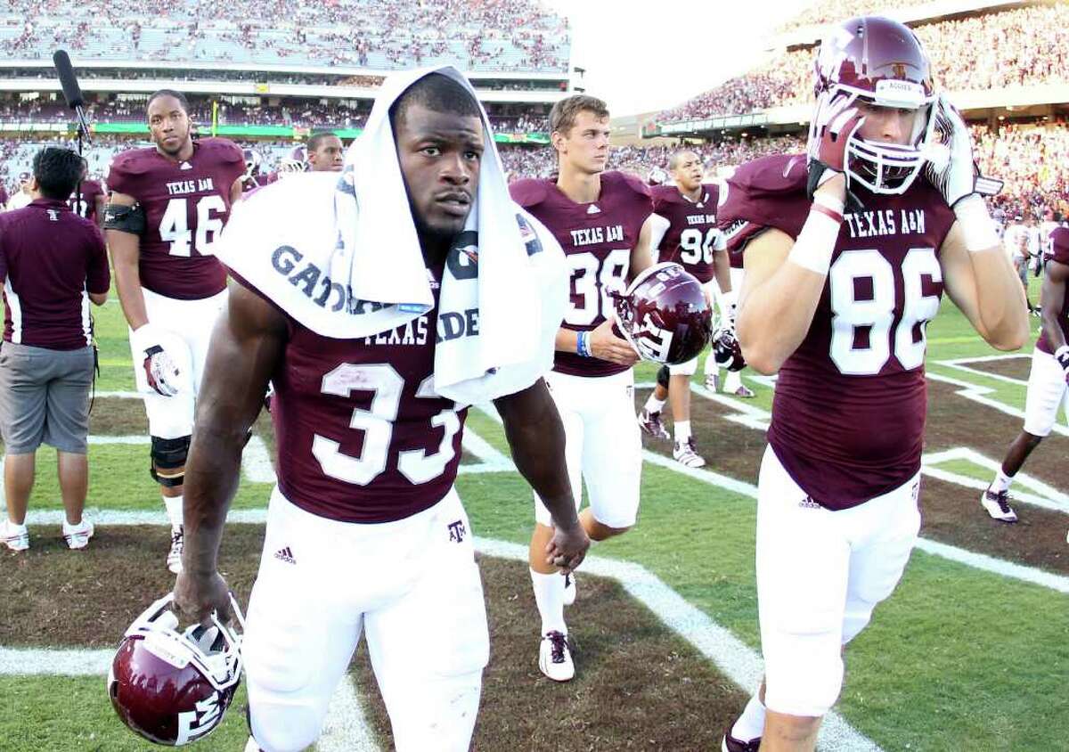 Texas A&M running back Christine Michael (33) and his teammates walk off the field after loosing to Oklahoma State 30-29 in a NCAA football game, Saturday, Sept. 24, 2011, in Kyle Field in College Station. Oklahoma State won 30-29.