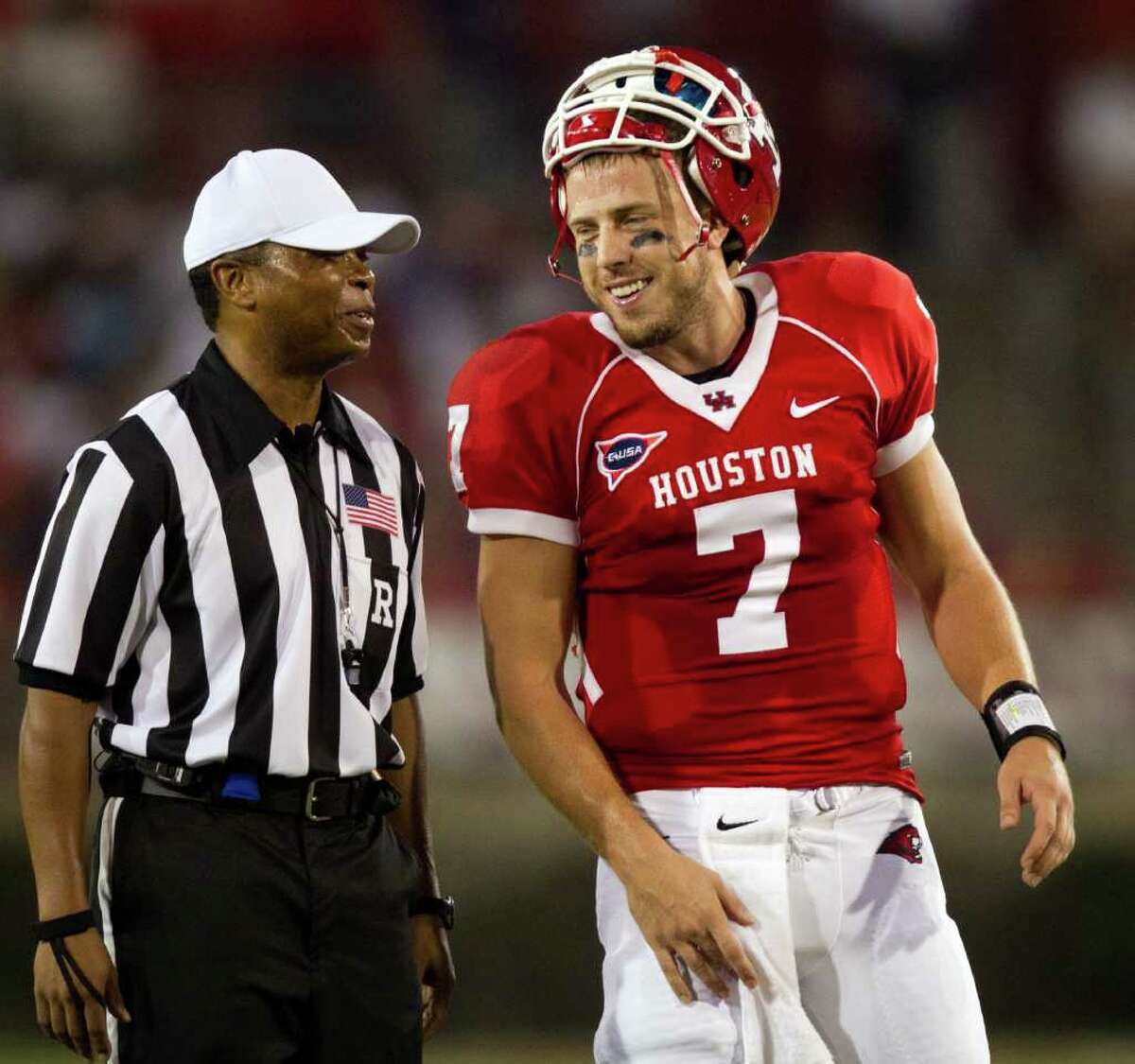 Houston Cougars quarterback Case Keenum (7) laughs with referee Jerry Banks during the first half of an NCAA football game against the Georgia State Panthers at Robertson Stadium, Saturday, Sept. 24, 2011, in Houston.