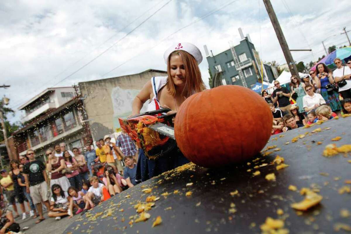 Nicole Haustueit, nicknamed "Betsy Sailor," competes in the Texas Chainsaw Pumpkin Carving competition.