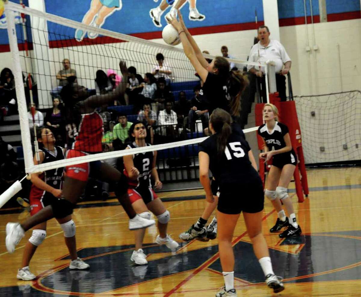Cheyenne Haslett goes for the block for Staples in its 3-0 win at Brien McMahon Friday.