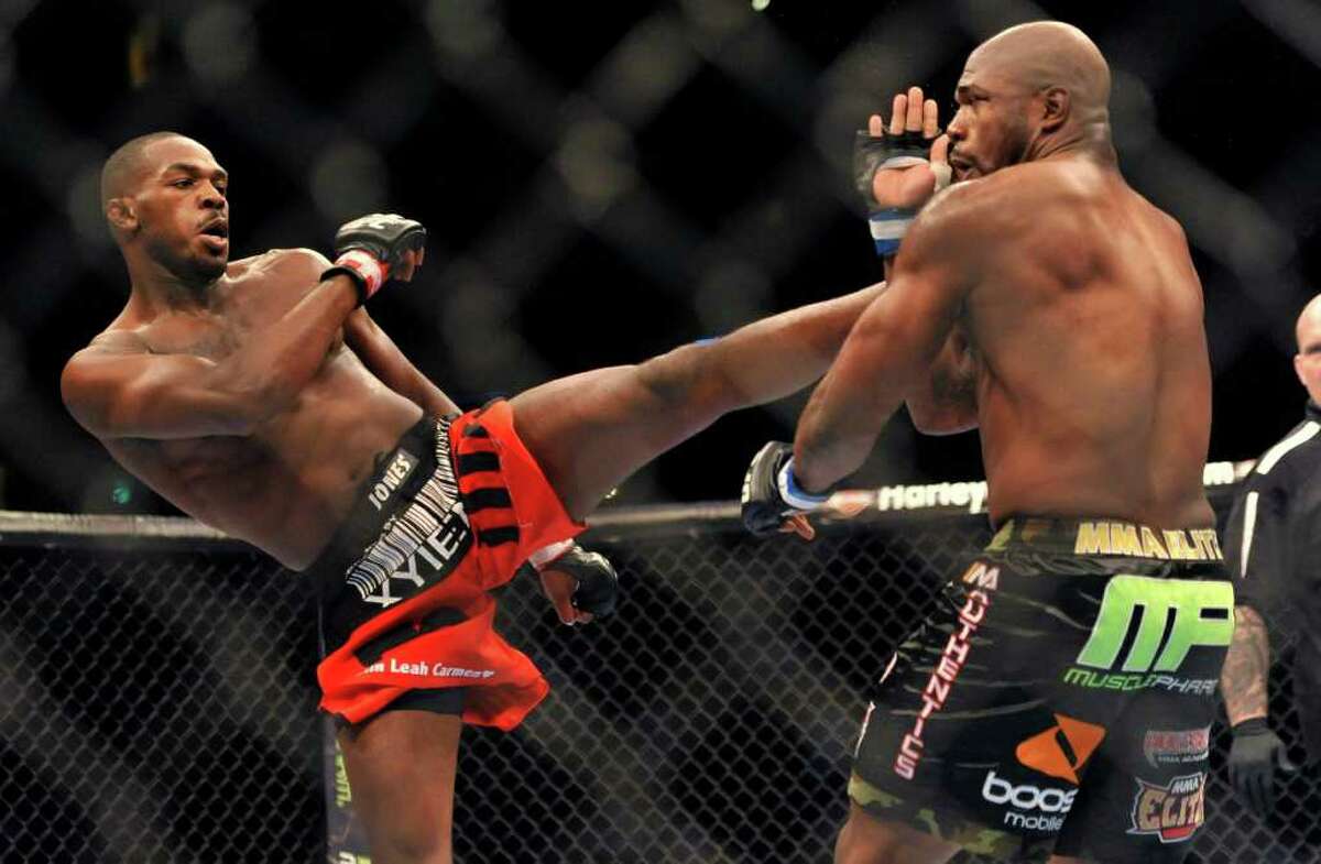Jon Jones, left, of Endicott, N.Y., gets in a kick to the head of Rampage Jackson, of Irvine, Calif., during the first round of their UFC Light Heavyweight title bout, Saturday, Sept. 24, 2011, in Denver. (AP Photo/ Jack Dempsey )