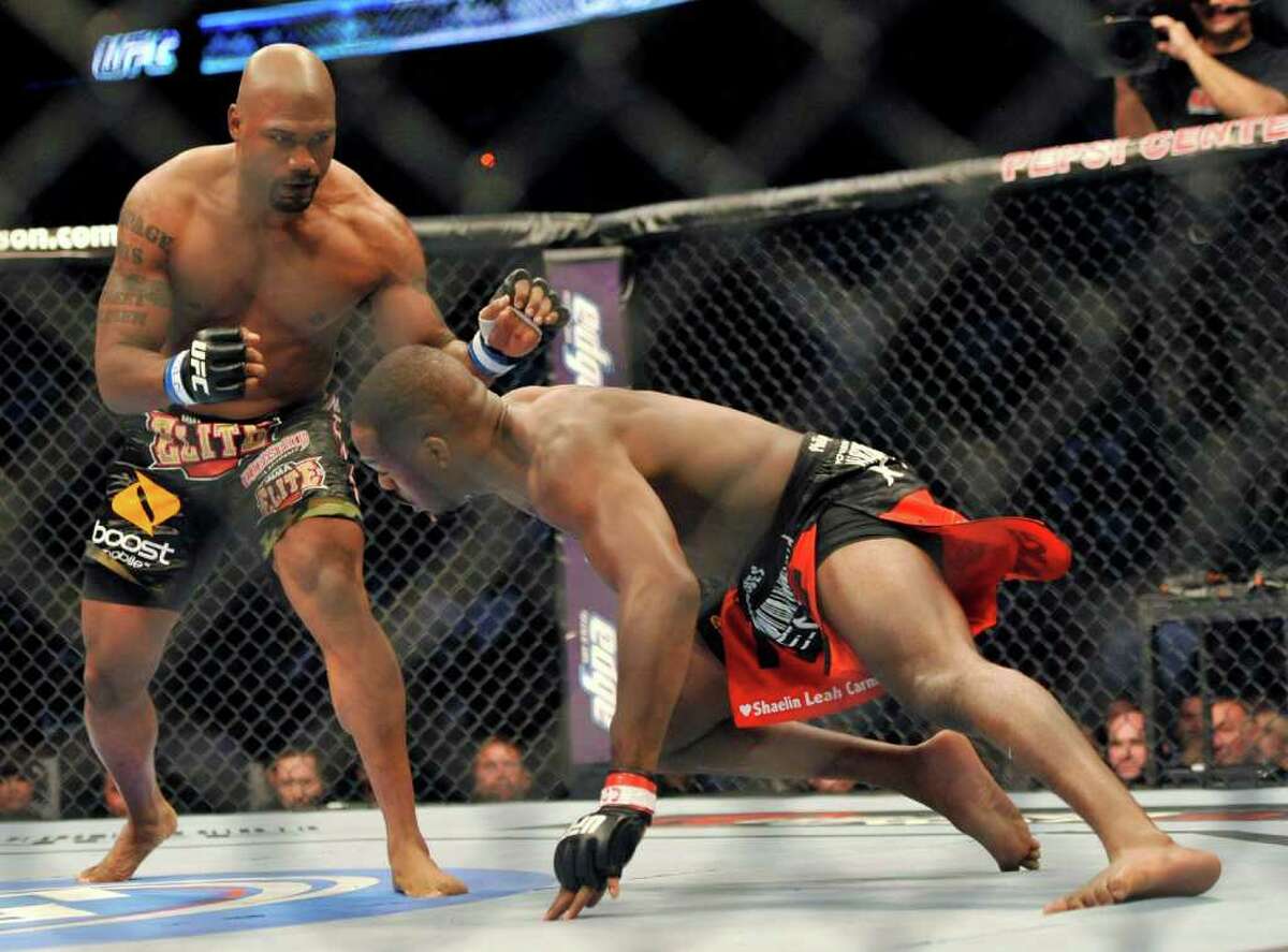 Jon Jones, right, of Endicott, N.Y., and Rampage Jackson, of Irvine, Calif., battle during the first round of their UFC Light Heavyweight title bout, Saturday, Sept. 24, 2011, in Denver. (AP Photo/ Jack Dempsey )