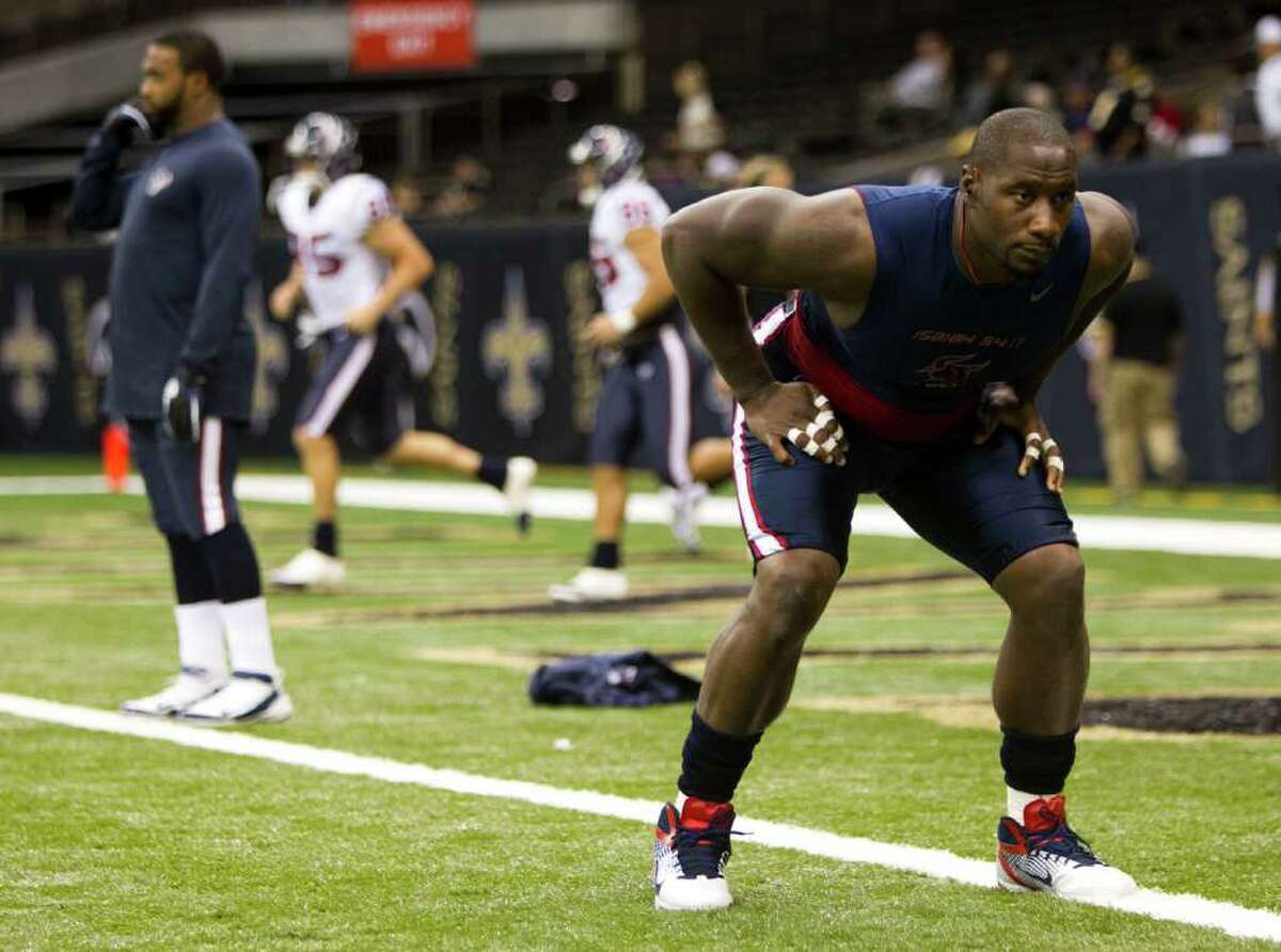 Houston Texans defensive end Antonio Smith stretches out before an NFL football game against the New Orleans Saints at the Louisiana Superdome Sunday, Sept. 25, 2011, New Orleans.