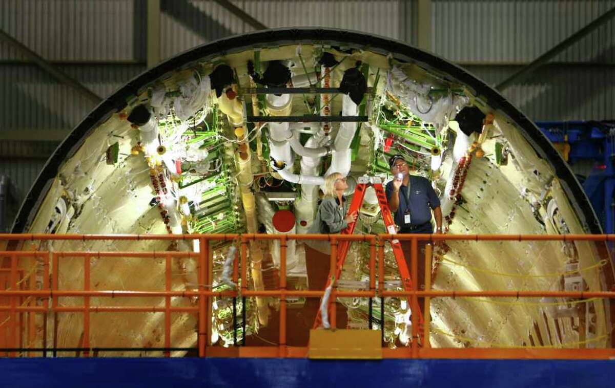 Workers assemble the fuselage of a 787, seen during a tour of the 787 assembly line at the Boeing plant in Everett. Boeing is set to deliver the first 787 to launch customer All Nippon Airways.
