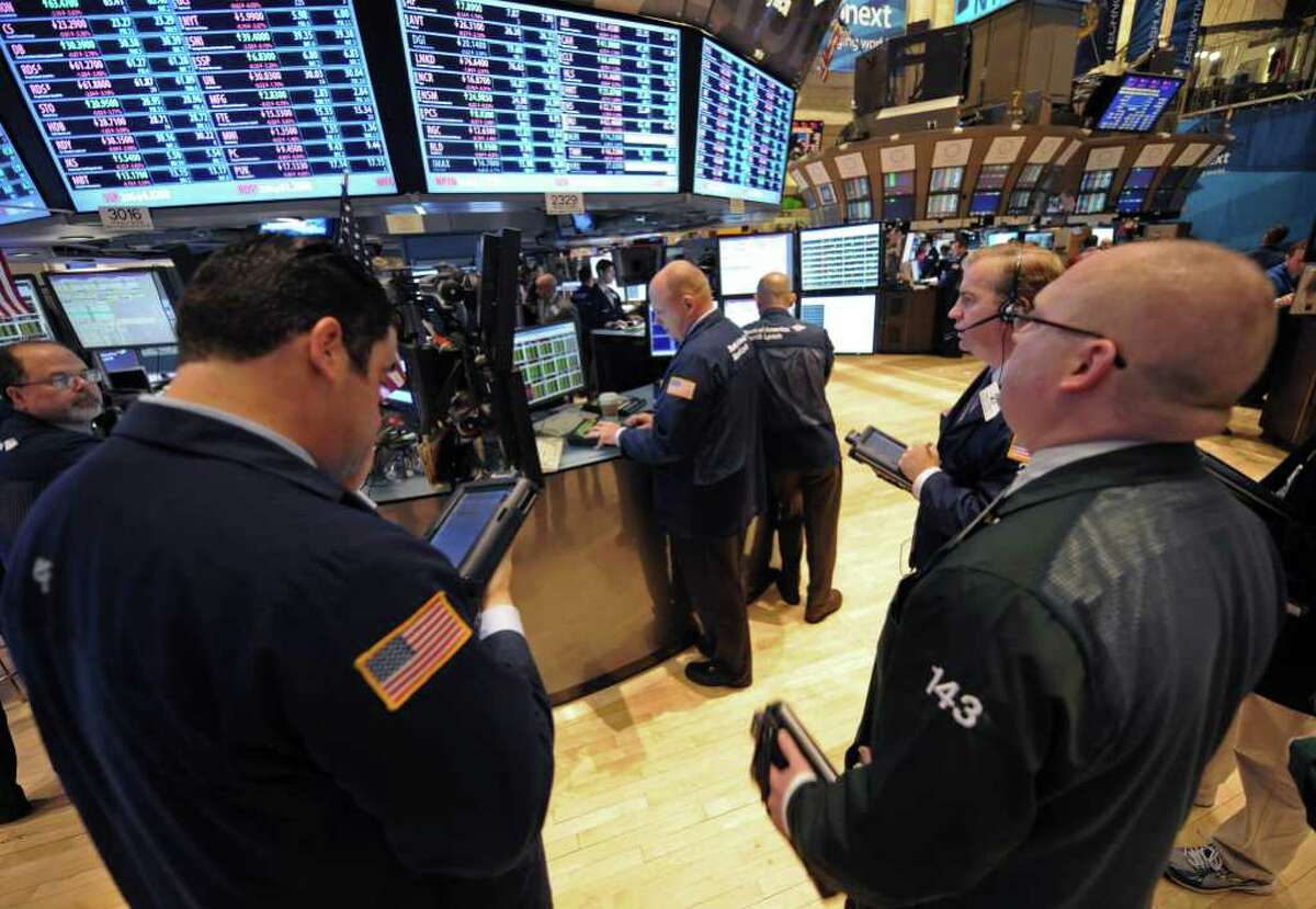In this Sept. 22, 2011 photo, traders work on the floor of the New York Stock Exchange, in New York. Hopes that European leaders will consider new ways to fight the debt crisis, including a contained Greek default, reassured investors on Monday, Sept. 26, 2011, though analysts said more specifics will have to emerge before a rally gains traction. (AP Photo/ Louis Lanzano)