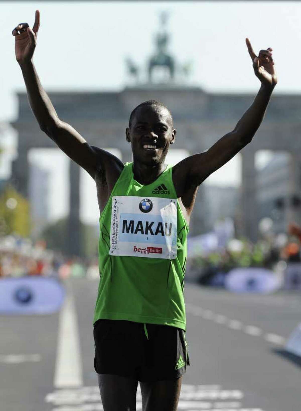 Patrick Makau of Kenya celebrates after winning the 38th Berlin Marathon on September 25, 2011 in Berlin. He set a new world record in an official time of 2hr 03min 38sec. AFP PHOTO ODD ANDERSEN (Photo credit should read ODD ANDERSEN/AFP/Getty Images)