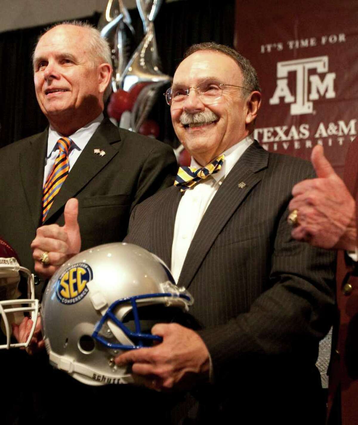 The University of Florida president Bernie Machen, who is also the chairman of SEC leaders, center, and Texas A&M president R. Bowen Loftin pose for a picture as Texas A&M officially enters the SEC, Monday, Sept. 26, 2011, in Kyle Field in College Station.