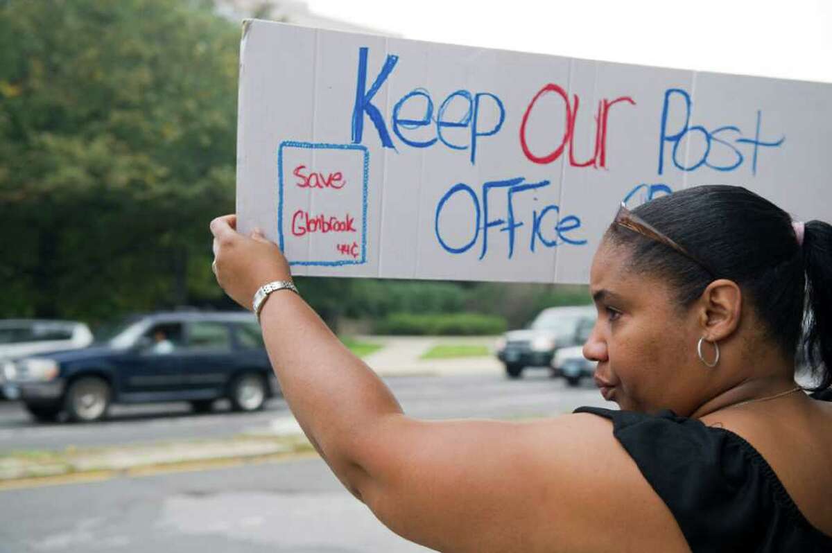 Postal worker Tara Ellis rallies outside the Government Center in Stamford, Conn., Sept. 27, 2011. Clerks and mail carries protest proposed postal service cuts that would close the West Avenue processing facility and the Glenbrook Post Office.