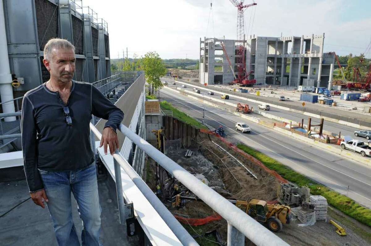 Dr. Alain E. Kaloyeros, Senior Vice President and Chief Executive Officer, College of Nanoscale Science and Engineering, watches new construction across Washington Avenue Extension at the college on Tuesday Sept. 27, 2011 in Albany, NY. Governor Andrew Cuomo announced this morning that IBM and the Intel Corporation will place research and development operations there. The beginnings of a pedestrian bridge to cross the road can be seen in the median at right. ( Philip Kamrass / Times Union)