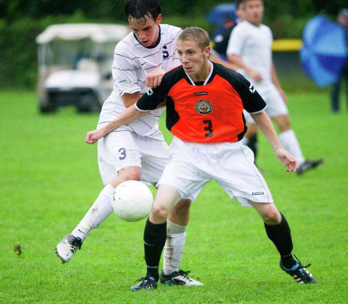 Staples' Ben Root and Ridgefield's Travis Leiter in action as Staples High School hosts Ridgefield in a boys soccer game in Westport, Conn., Sept. 28, 2011.