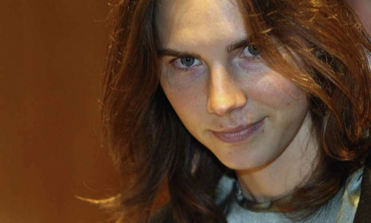 Amanda Knox is escorted to her appeal hearing at Perugia's Court of Appeal on Thursday.