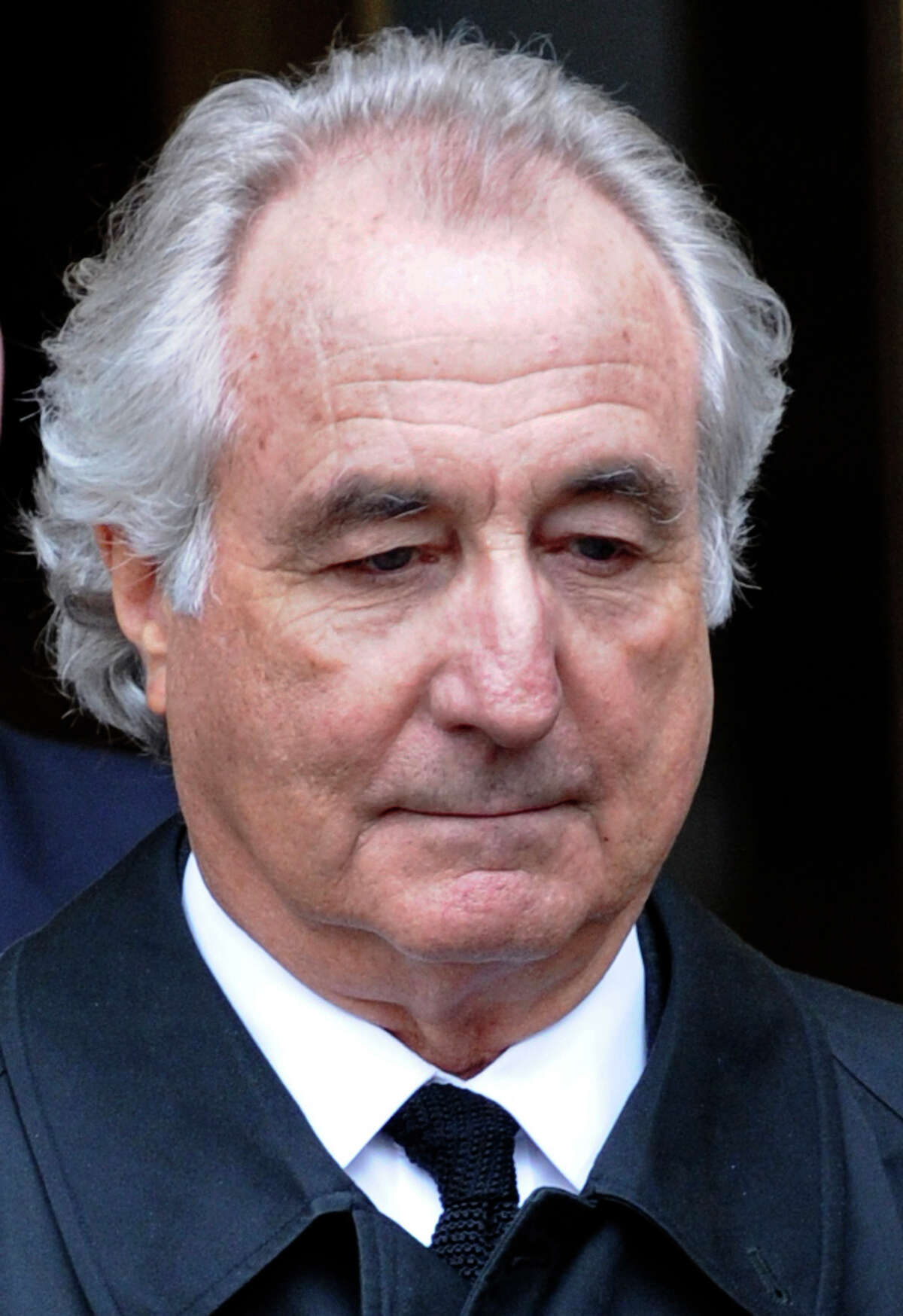 FILE - In this March 10, 2009 file photo, Bernard Madoff exits Manhattan federal court in New York. The trustee recovering money for Bernard Madoff's burned investors has reached a settlement with the estate of a Florida philanthropist and businessman who made billions of dollars off the fraud. Court-appointed trustee Irving Picard planned an announcement Friday in Manhattan about the estate of Jeffry Picower, who drowned after suffering a heart attack in the swimming pool of his Palm Beach, Fla., mansion on Oct. 25, 2009. (AP Photo/Louis Lanzano, file)