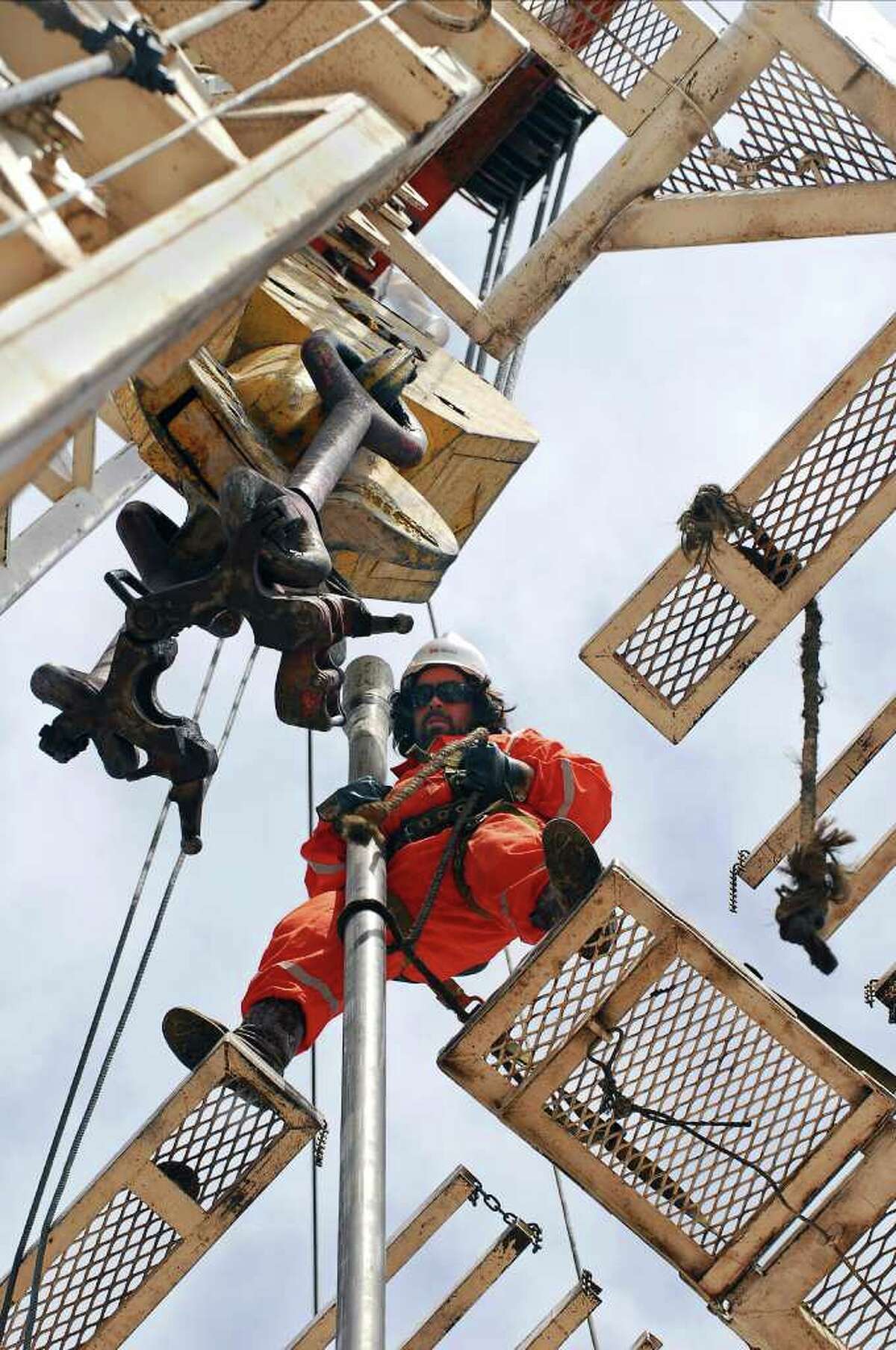 In this picture taken Nov. 24, 2009, an oil worker works on an oil drill in the province of Neuquen, Argentina. Argentina is promoting a new era of mining and energy production, welcoming billions of dollars in foreign investment to unlock huge new reserves of natural gas, oil, gold, lithium and other metals once thought to be unprofitable or out of reach. But there's one factor threatening this resource boom, something politicians and energy executives rarely mention: Huge amounts of fresh water will be required to extract these resources, in a country where water scarcity has long held back development and 16 percent of households still aren't connected to publicly treated drinking water. (AP Photo/Leonardo Petricio)