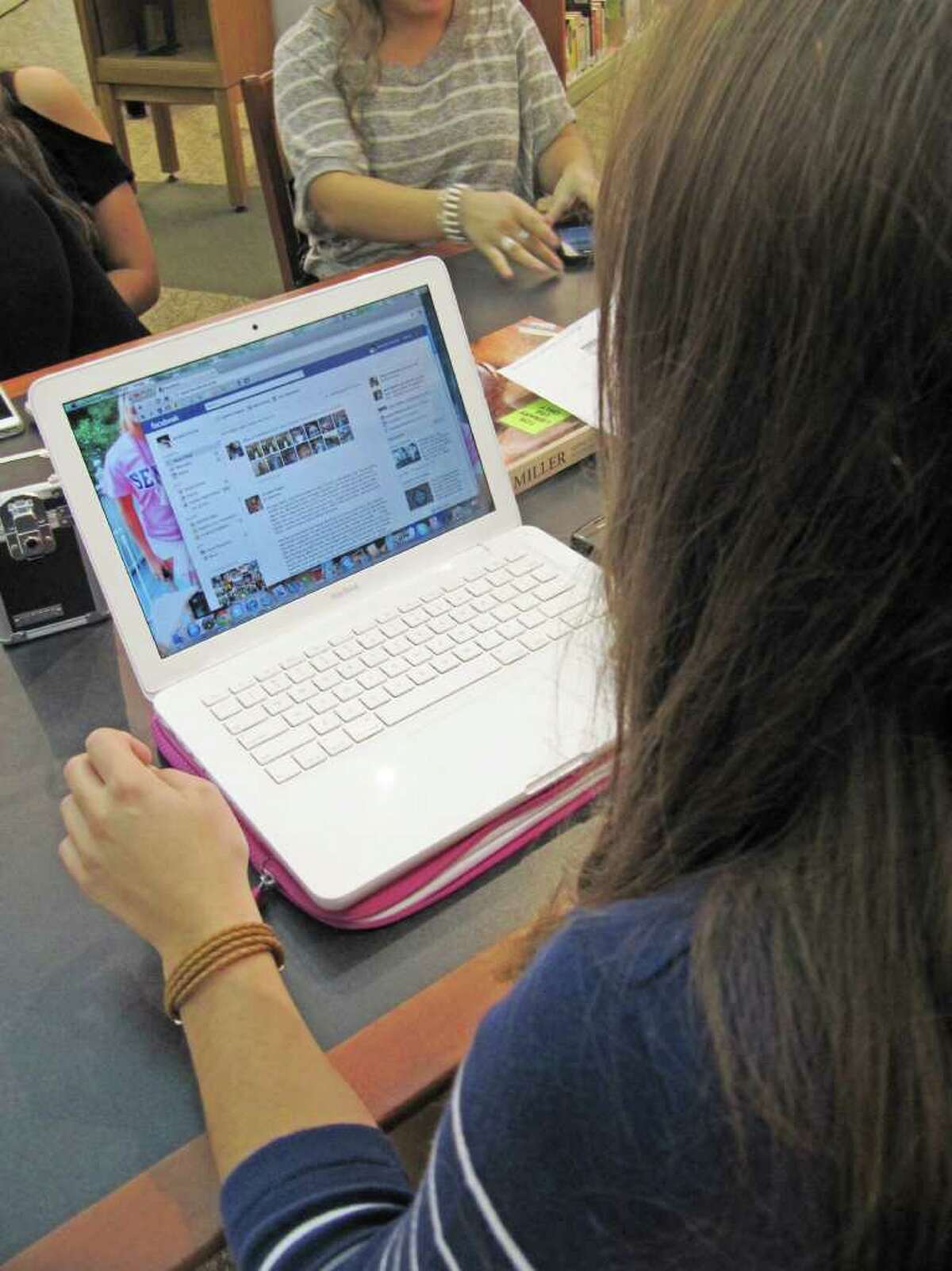 Staples High School senior Amanda Pacilio logs onto Facebook.com while at the school's library Tuesday afternoon. John Dodig, Staples' principal, announced on Aug. 25 he was lifting a nearly five-year ban of the social networking site. In nearby Fairfield, all social networking sites are banned district-wide.