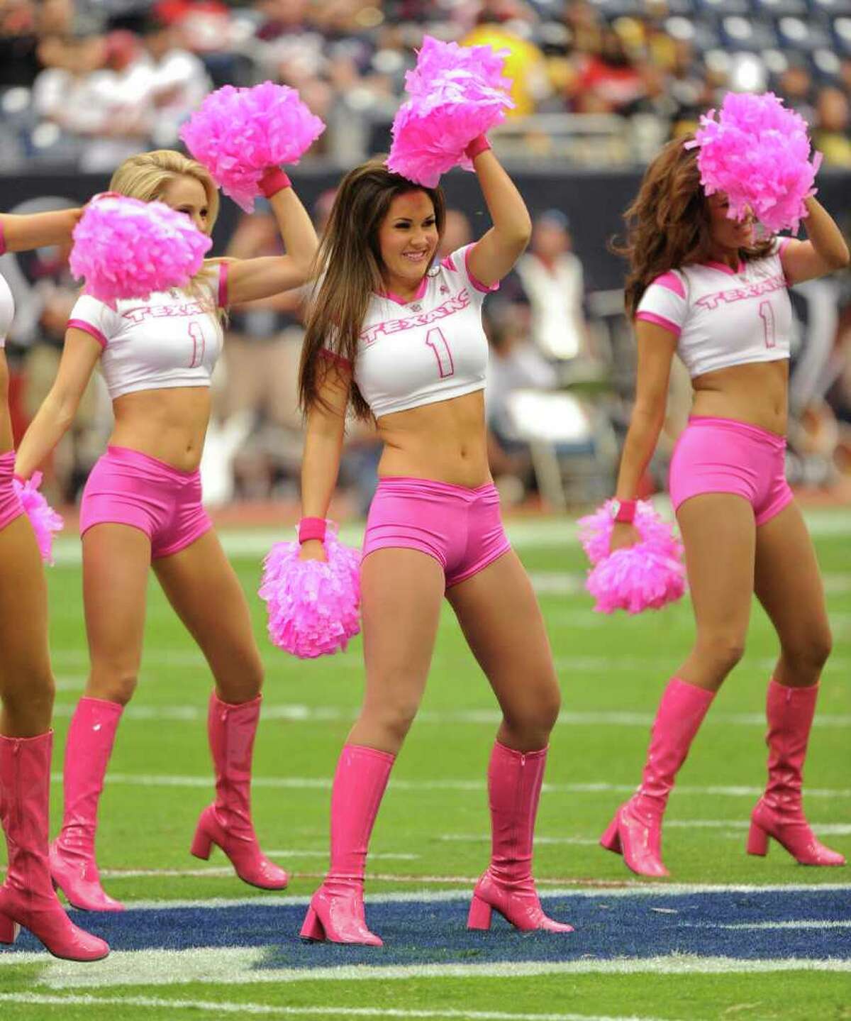 Houston Texans cheerleaders adorn their pink outfits as October is