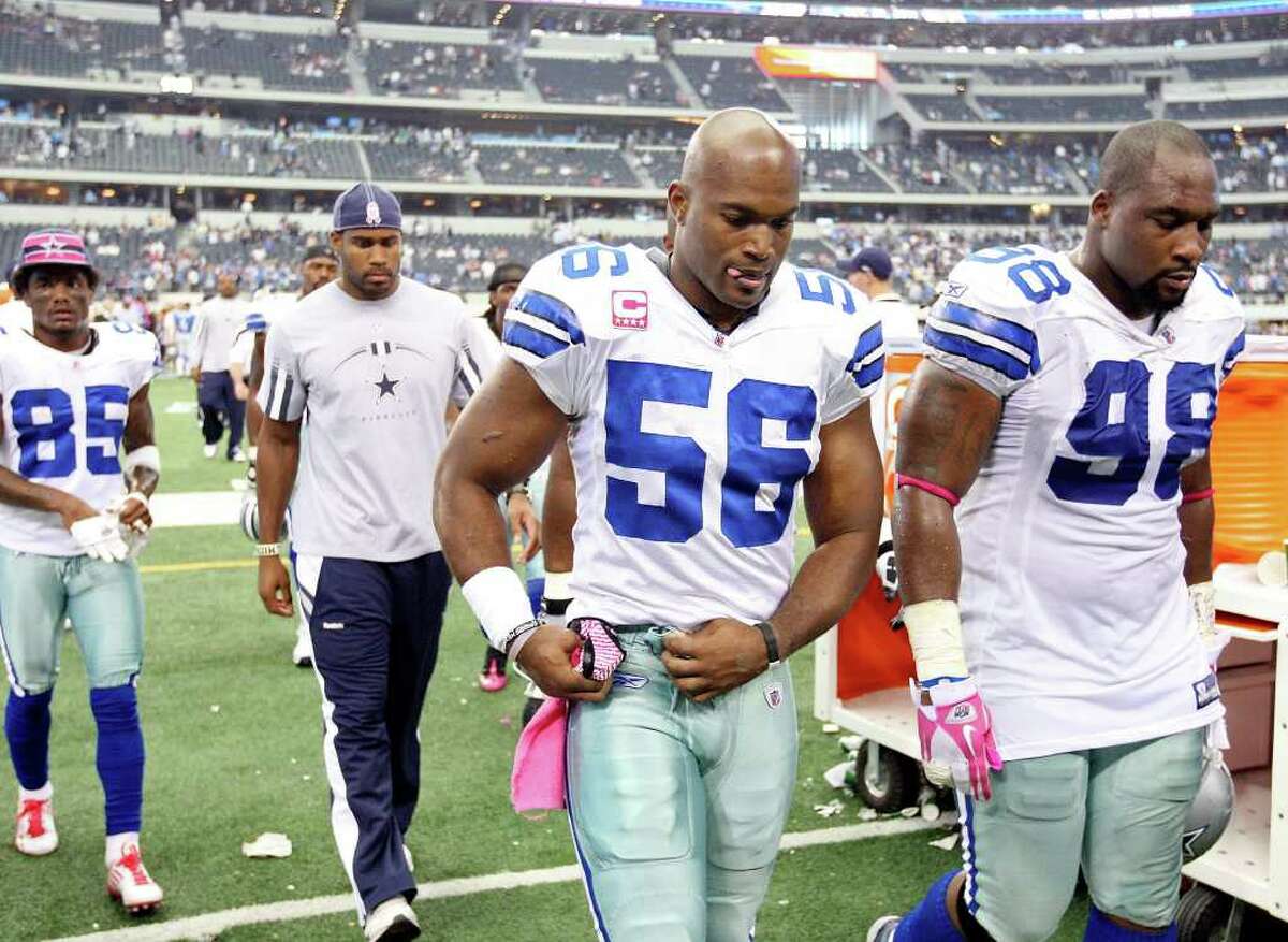 FOR SPORTS - Dallas Cowboys' Bradie James (left) and teammate Dallas Cowboys' Marcus Spears leave the field after the game with the Detroit Lions Sunday Oct. 2, 2011 at Cowboys Stadium in Arlington, TX. The Lions won 34-30. (PHOTO BY EDWARD A. ORNELAS/eaornelas@express-news.net)