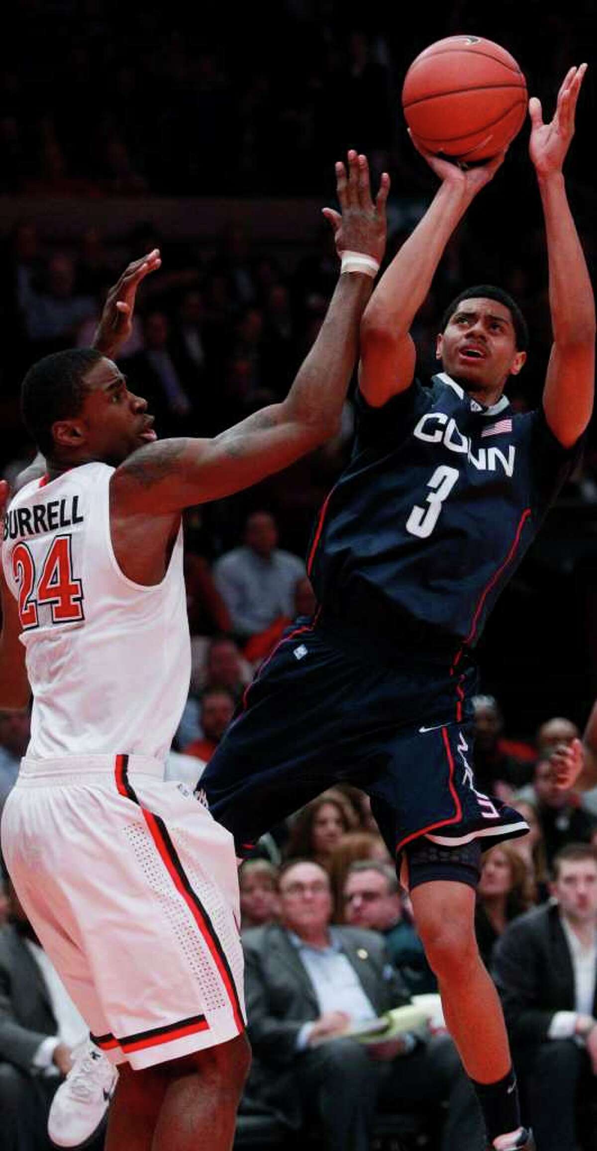 Connecticut's Jeremy Lamb (3) shoots over St. John's Justin Burrell (24) in the first half of an NCAA college basketball game on Thursday, Feb. 10, 2011, in New York. (AP Photo/Frank Franklin II)