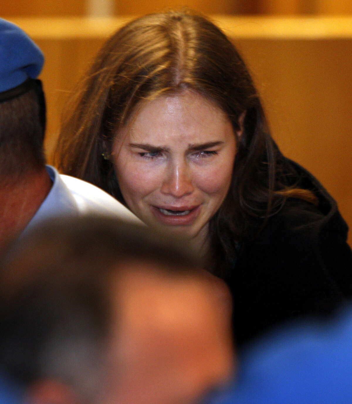 Amanda Knox breaks in tears after hearing the verdict that overturns her conviction and acquits her of murdering her British roommate Meredith Kercher, at the Perugia court, central Italy, Monday, Oct. 3, 2011.  (AP Photo/Pier Paolo Cito)