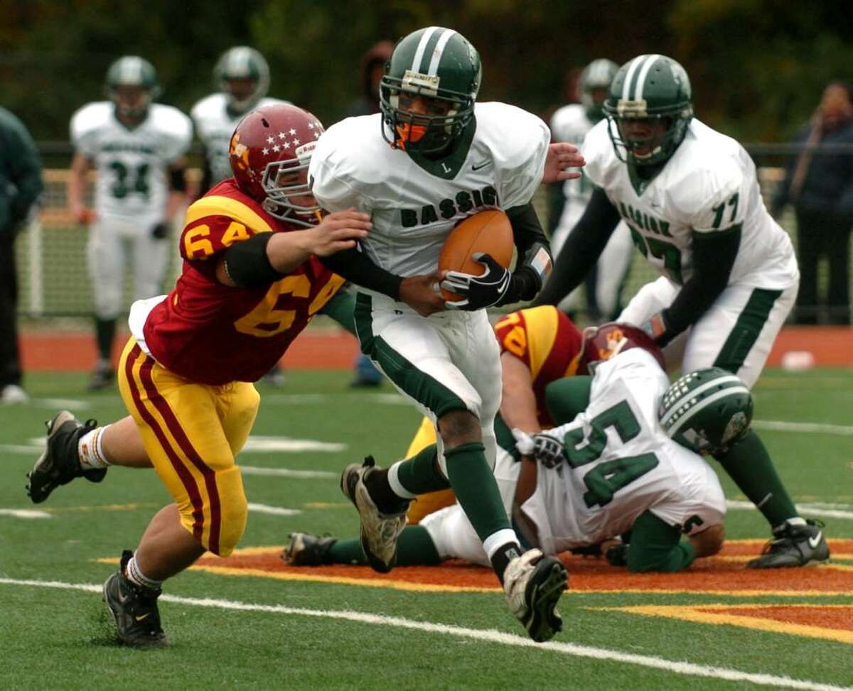St. Joseph's #64 Russ Renfer sacks Bassick QB Rodney Lanham, during game action in Trumbull, Conn. on Saturday Oct. 17, 2009. Lanham dropped the ball which was recovered by St. Joe's #44 Tyler Matakevich.