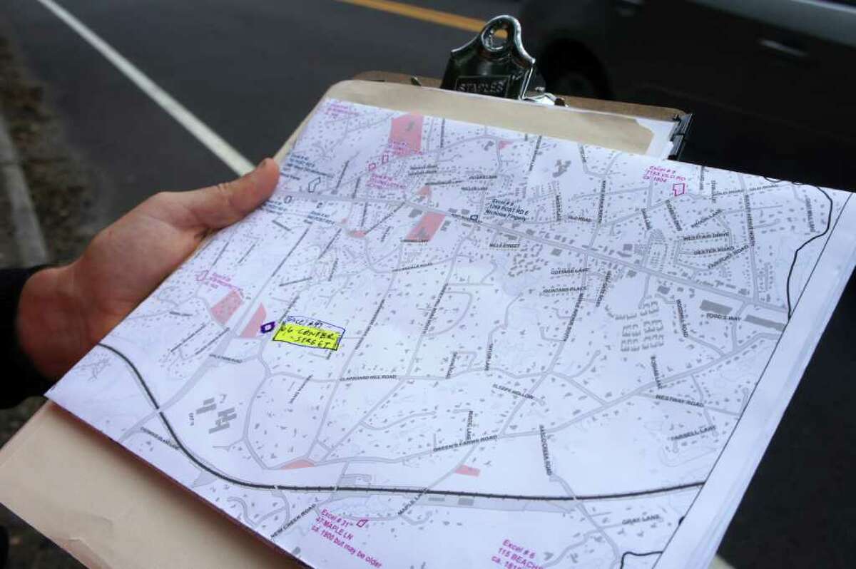 Assistant architectural historian Blake McDonald holds a map that shows properties surveyed for Westport's updated Historic Resources Inventory.