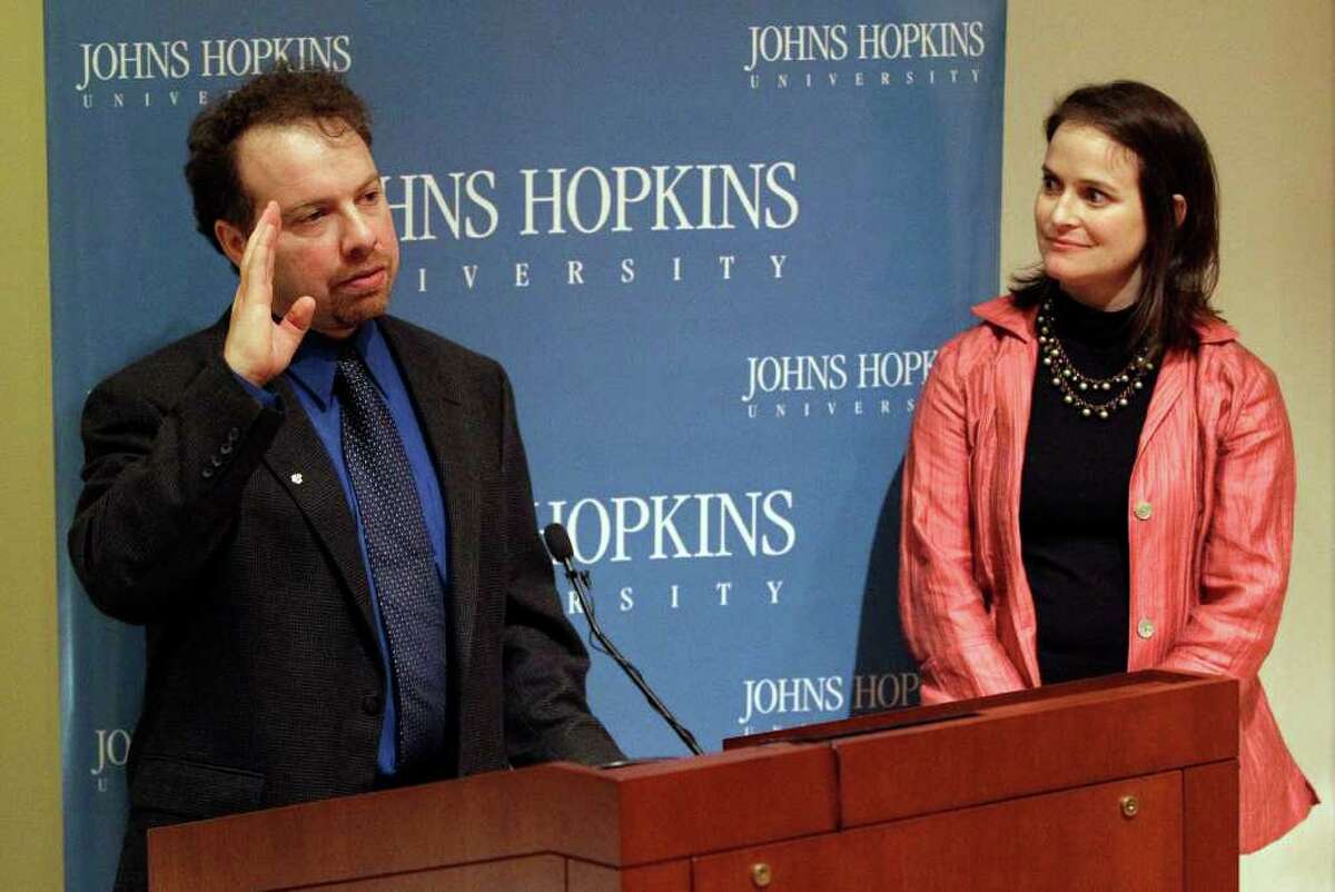 Dr. Adam Riess, left, speaks alongside his wife Nancy, a Greenwich native, at a news conference to acknowledge his Nobel Prize in Physics at Johns Hopkins University in Baltimore, Tuesday, Oct. 4, 2011. Riess shared the prize with Saul Perlmutter, an astrophysicist at the University of California, Berkeley, and Brian Schmidt of the Australian National University, for their contributions to the discovery that the universe's expansion is accelerating. (AP Photo/Patrick Semansky)