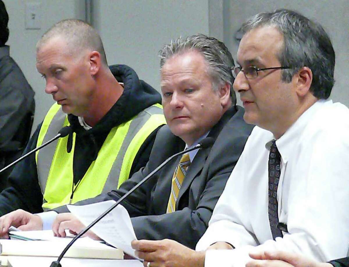 At Tuesday's Board of Finance meeting, from left, Mike Shutler, from Tecta America New England; Board of Education Facilities Manager Tom Cullen and Sal Morabito, manager of construction, security and safety for the school board, answer questions about roof repairs and warranty extension.