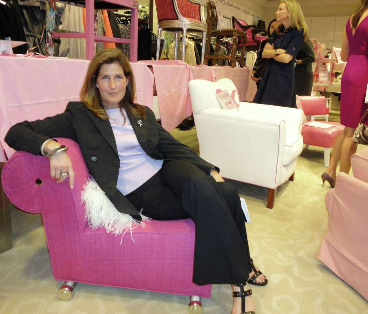 Linherr Hollingsworth of Hollingsworth Design Associates poses Wednesday in the chair she designed for the inaugural Pink Aid Pink Chairs Luncheon and Fashion Show at Mitchellís in Westport. Hollingsworth said she doesnít usually design with such bold colors as the bright pink she used for the chair but enjoyed the project because the pink represents ìthe bold spirit that is within all those women (battling breast cancer) to survive, to keep going on.î