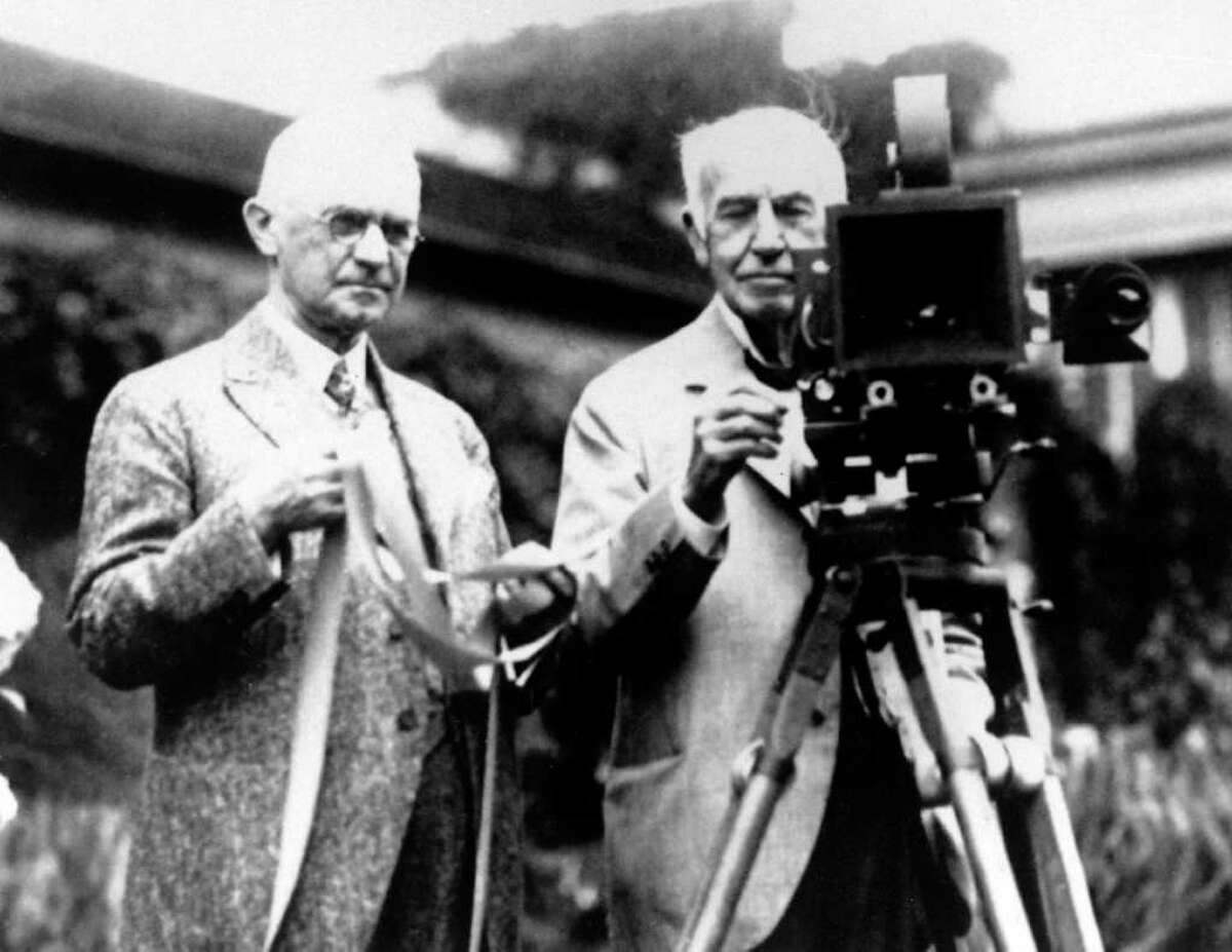 FILE - In this late 1020's file photo, Eastman Kodak Co. founder George Eastman, left, and Thomas Edison pose with their inventions in a photograph taken in the late 1920s. Their contributions, Edison invented motion picture equipment and Kodak invented roll-film and the camera box, helped create the motion picture industry. Buffeted by fierce foreign competition, then blindsided by a digital revolution, photography icon Eastman Kodak Co. is teetering on a financial precipice after a quarter-century of failed efforts to find its focus. (AP Photo)