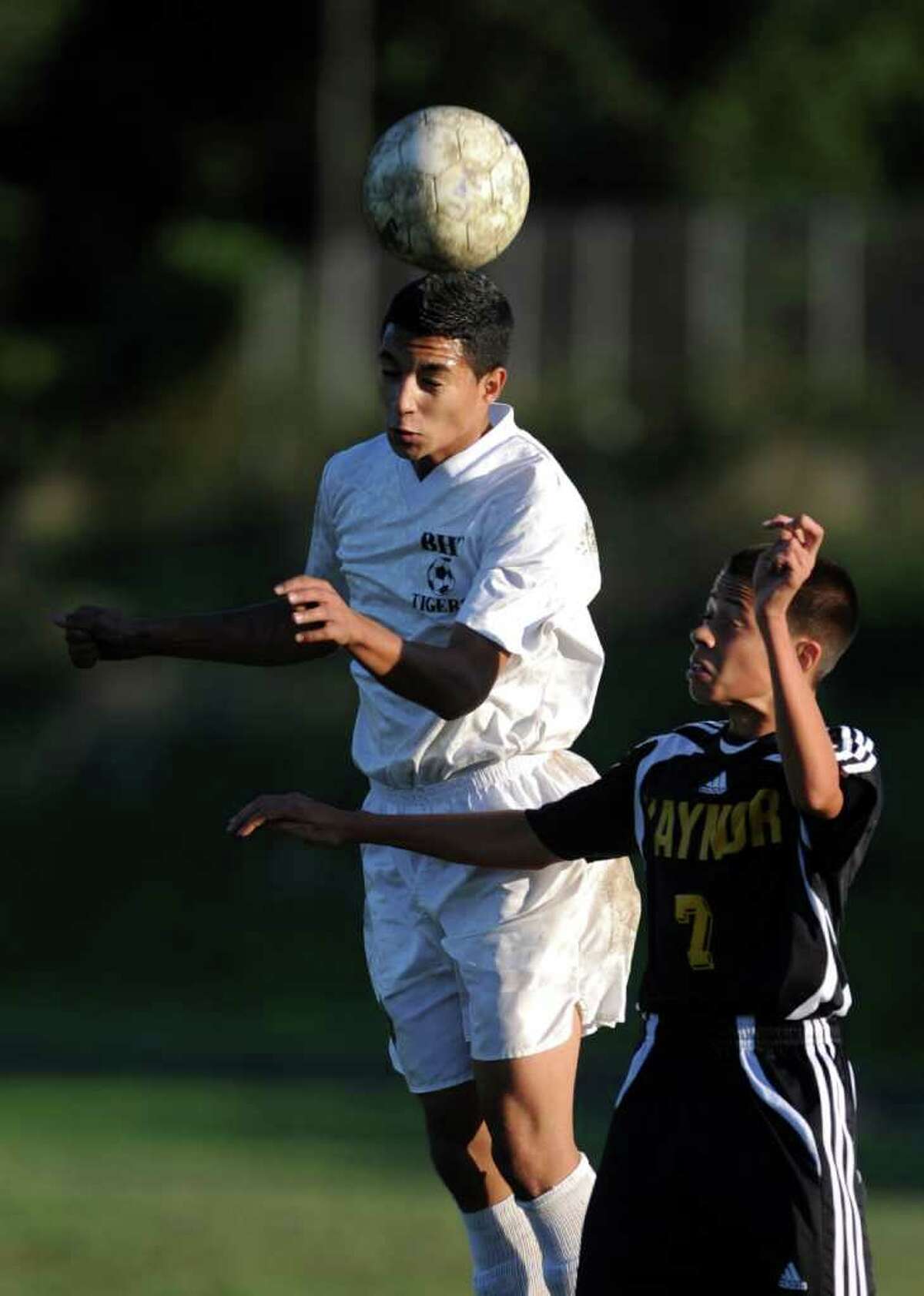 Bullard-Havens' Milton Vela heads the ball as Kaynor Tech's Tyler Lillo defends during their soccer match Wednesday, Oct. 5, 2011 at the Bullard Havens campus in Bridgeport, Conn.