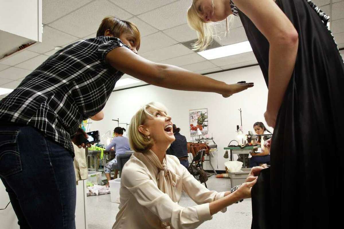 Houston fashion designer Jerri Moore (center) makes a last-minute adjustment to a dress worn by model Alyssa Pasek (right) as design assistant Tanesha Seafous (left) helps during a final fitting of Moore's collection for Fashion Houston, Tuesday, Sept. 27, 2011, in Houston. ( Michael Paulsen / Houston Chronicle )