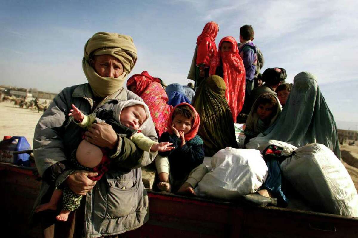 Internally displaced persons prepare to relocate as U.S. planes and special forces begin an assault in northern Afghanistan in October of 2001. Photojournalist Joshua Trujillo traveled there for Hearst Newspapers in October of 2001 to cover the U.S. response to the terror attacks on the United States. These photos are being shared 10 years after the beginning of the U.S. response.