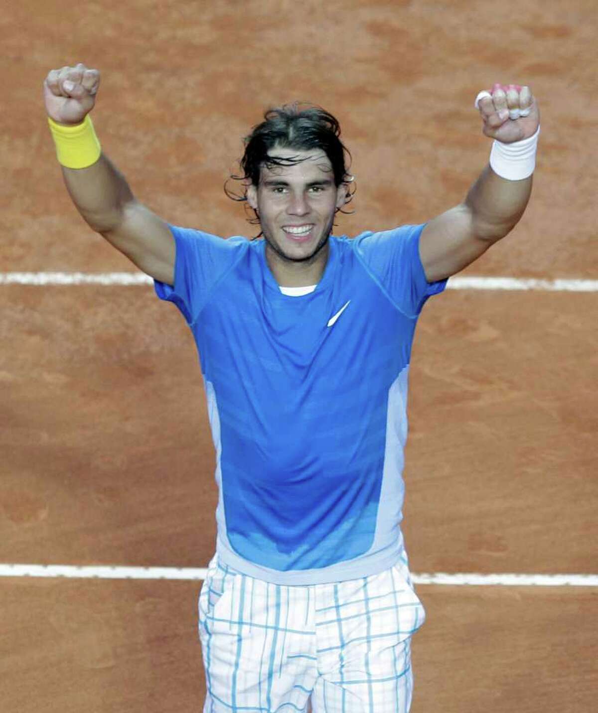 Rafael Nadal of Spain celebrates after beating Stanislas Wawrinka of Switzerland at the Rome Masters tennis tournament, in Rome, Friday, April 30, 2010. Nadal beat Wawrinca 6-4, 6-1. (AP Photo/Alessandra Tarantino)