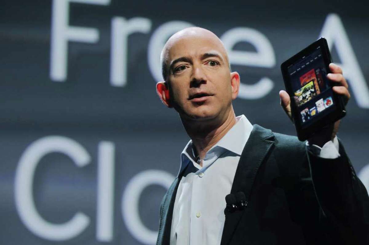 Spencer Platt : Getty Images APPLE RIVAL: Amazon.com founder Jeff Bezos displays the new Amazon tablet called the Kindle Fire. It could become the iPad's first credible challenger for market share.