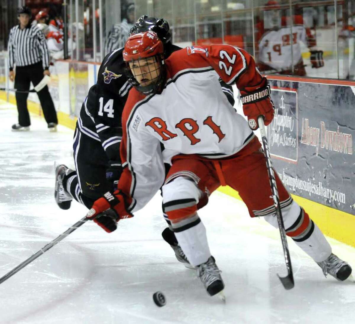 RPI'S C.J. Lee (22), right, battles for a loose puck with Minnesota State's Justin Jokinen (14) during their hockey game on Friday, Oct. 7, 2011, at Rensselaer Polytechnic Institute in Troy, N.Y. (Cindy Schultz / Times Union)