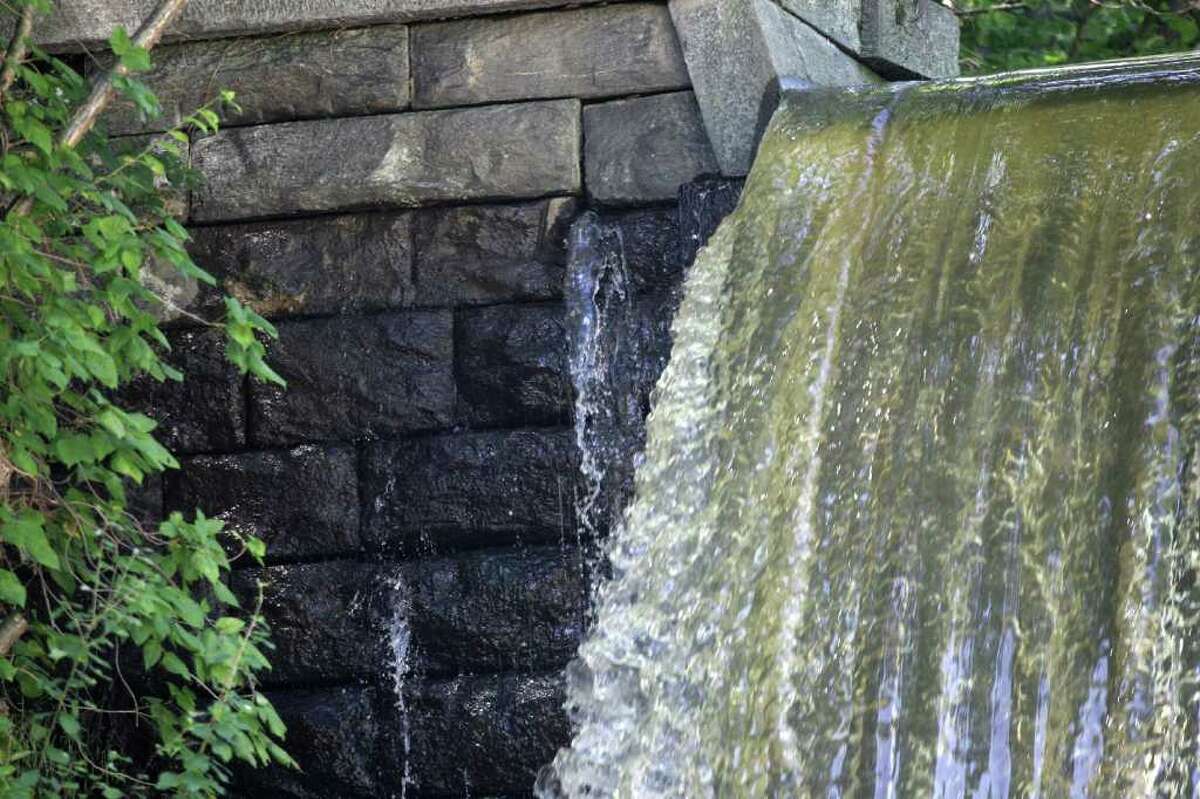 Water running over the Pemberwick Dam in western Greenwich, Sept. 9, 2011, after a period of heavy rain.