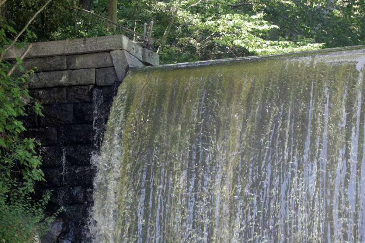 Water running over the Pemberwick Dam in western Greenwich, Sept. 9, 2011, after a period of heavy rain.