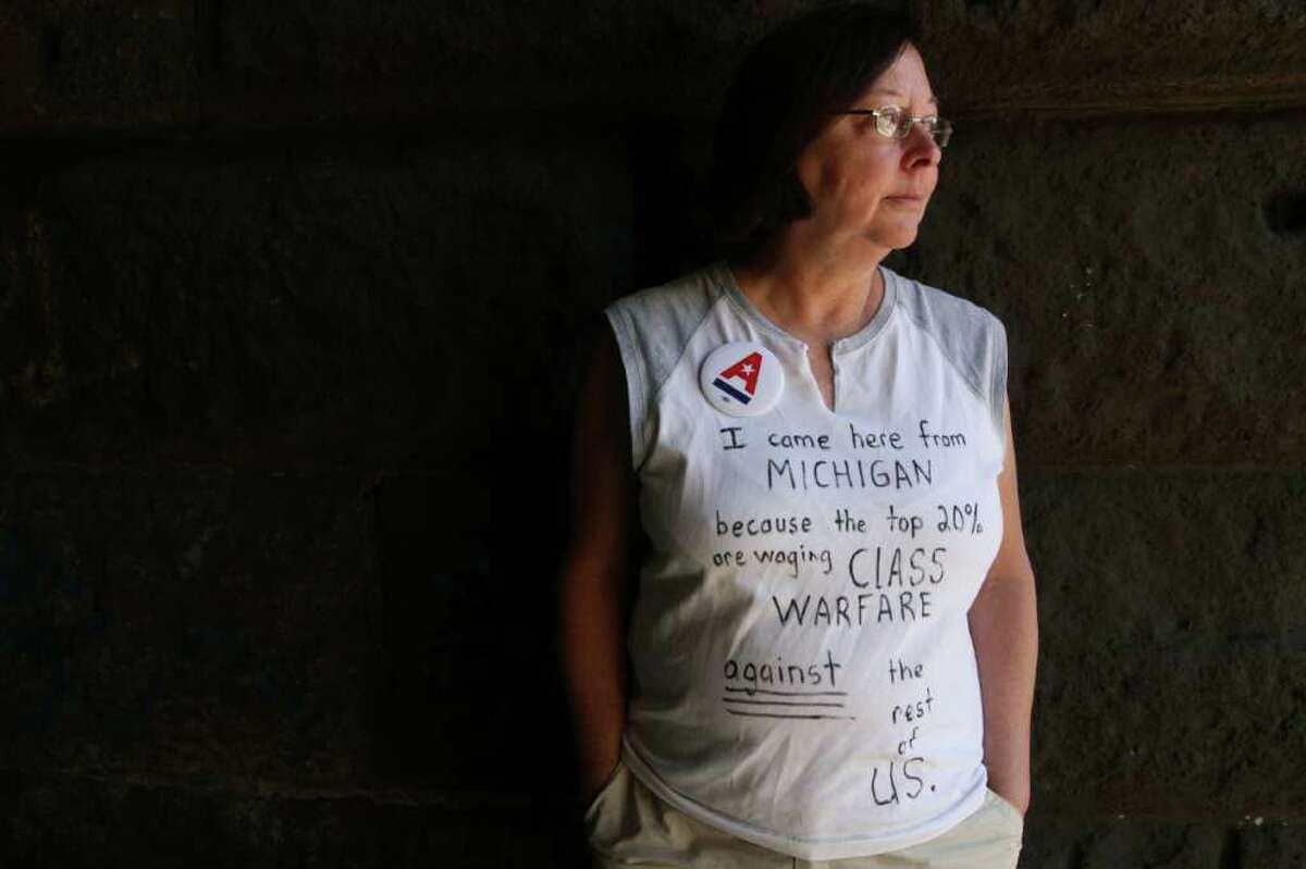 TINA FINEBERG : ASSOCIATED PRESS HUMAN SIGN: Cherie Walters, 58, from Mount Clemens, Mich., wears the shirt she wore to two of the Occupy Wall Street protests She was an anti-war protester in college