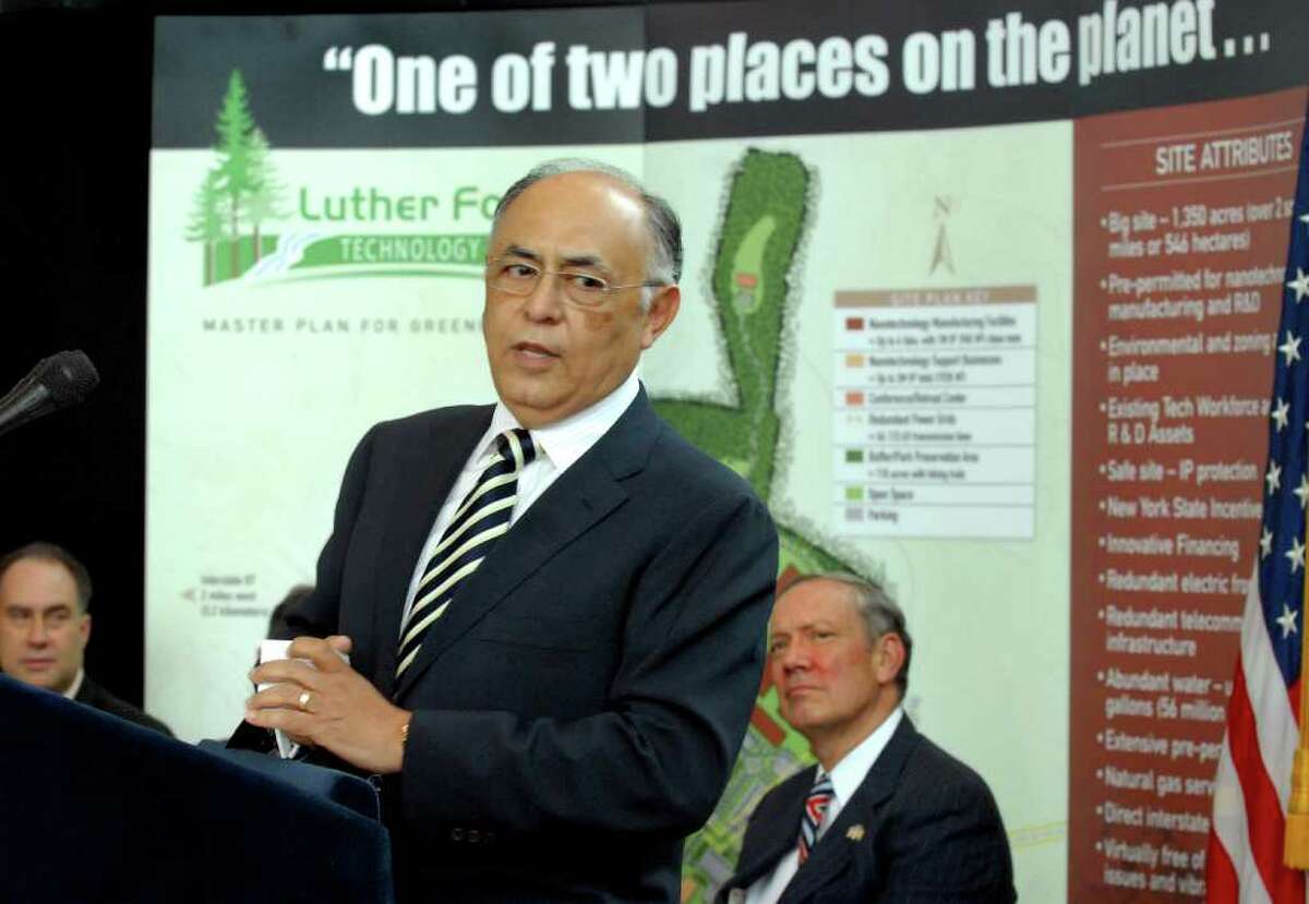 Times Union staff photo by Cindy Schultz -- Hector Ruiz, CEO and chairman of Advanced Micro Devices Inc. (AMD), center, speaks during a news conference on Friday, June 23, 2006, at CESTM in Albany, N.Y. AMD will build a computer chip fab plant in Luther Forest in Stillwater. (WITH STORY) (day 1)
