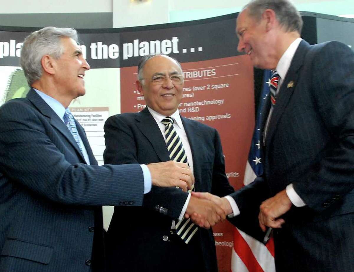 Times Union staff photo by Cindy Schultz Hector Ruiz, CEO and chairman of Advanced Micro Devices Inc. (AMD), center, shakes hands with Gov. George Pataki, right, and Sen. Joseph Bruno, left, during a news conference on Friday, June 23, 2006, at CESTM in Albany, N.Y. AMD will build a computer chip fab plant in Luther Forest in Stillwater. (day 1)