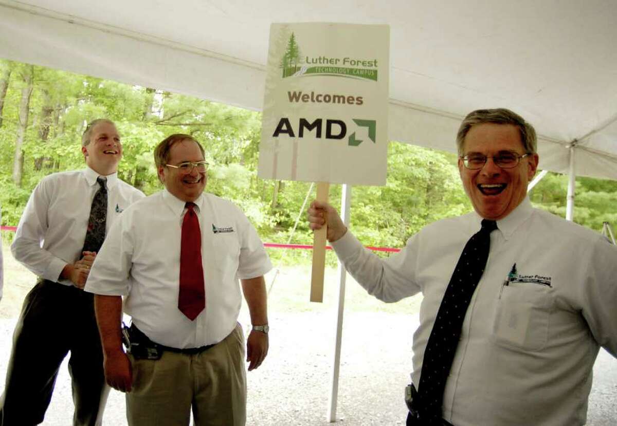 Kenneth Green, President of Saratoga Economic Development Corp, right, celebrates the announcement of an AMD chip fabrication plant to be built on the Luther Forest Tech Park in Malta, with SEDC Senior Vice President Jack Kelley, center, and Jon Dawes, left, also from SEDC, during a press conference Friday afternoon June 23, 2006. AMD would later spin off its manufacturing into GlobalFoundries.