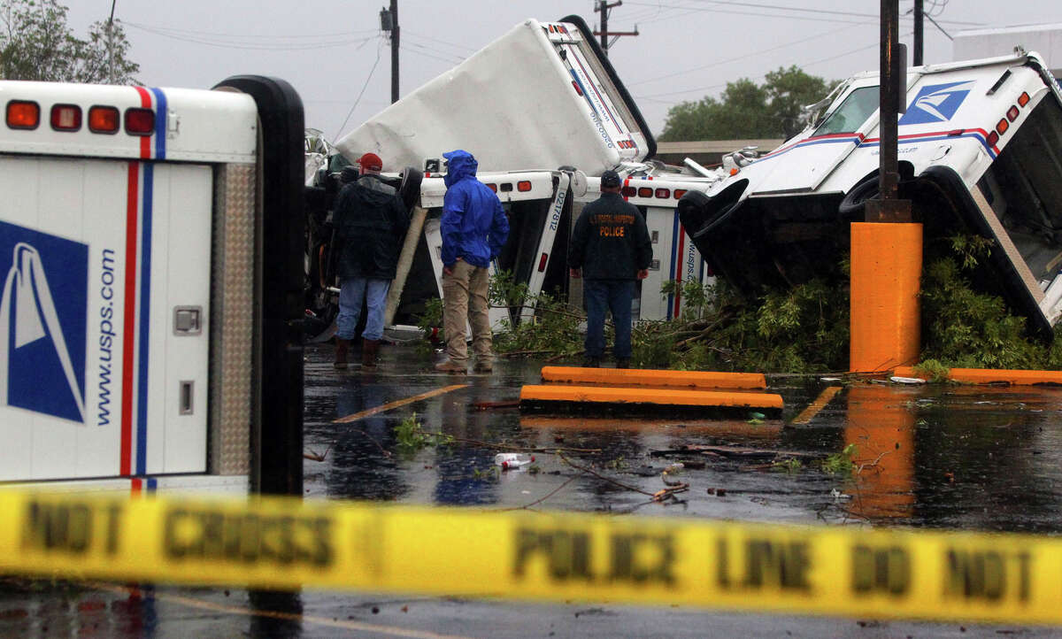 U.S. Postal trucks at the Valley Hi branch of the U.S Post Office were tossed about after high winds swept through the area early Sunday October 9, 2011.