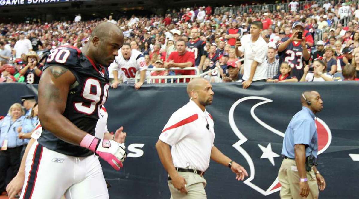 Houston Texans outside linebacker Mario Williams (90) leaves the game during the first quarter of an NFL football game against the Oakland Raiders at Reliant Stadium, Sunday, Oct. 9, 2011, in Houston.