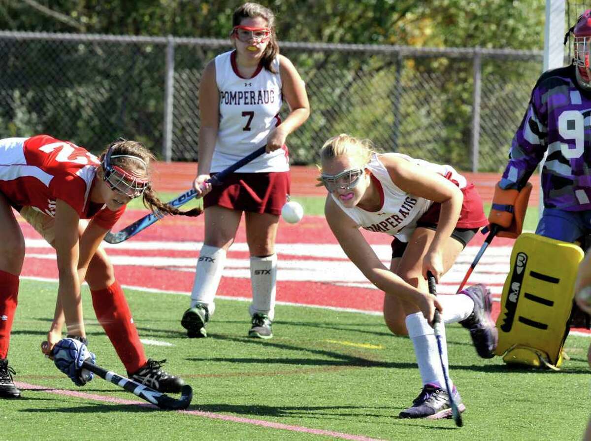 Pomperaug High School's #8 Kristy Matasavage blasts the ball against Greenwich High School in a Field Hockey game in Southbury Monday, Oct. 10, 2011.