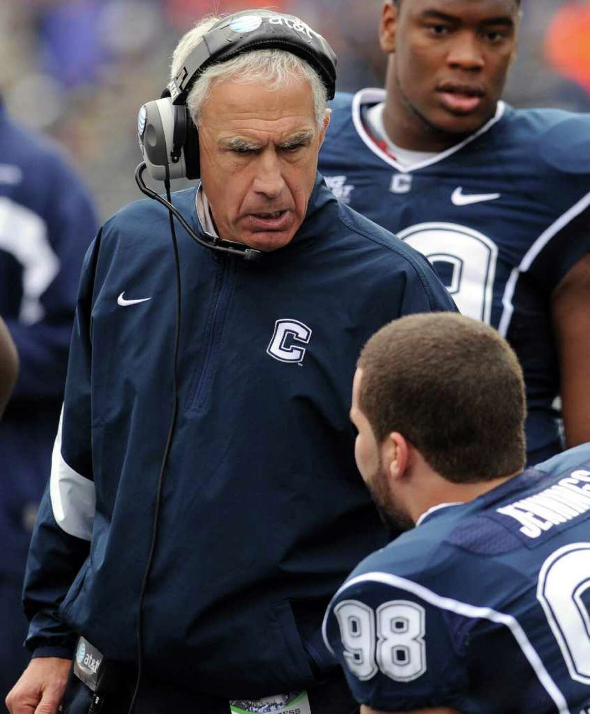 This Oct. 1, 2011 file photo shows Connecticut coach Paul Pasqualoni speaking with Ted Jennings (98) in the first quarter of an NCAA college football game against Western Michigan, in East Hartford, Conn. Pasqualoni says he tries to ignore the building chatter that he could be a one year-and done head coach at Connecticut unless the Huskies' season takes a dramatic turn for the better. (AP Photo/Jessica Hill, File)