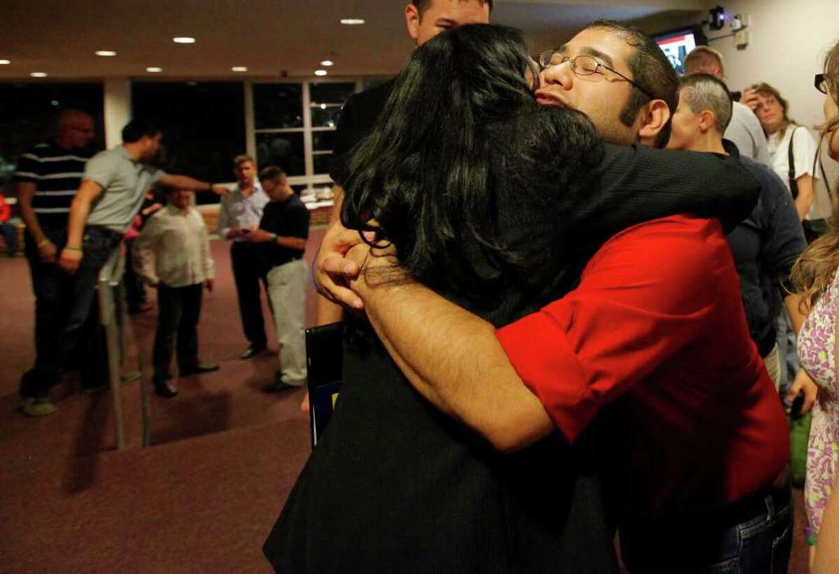 San Antonio College student and vice-president of GALA Rene Orozco (right) gives a hug to Parents, Friends and Families of Lesbians and Gays president Norma Ortega at the Coming Out Day event held at San Antonio College on Tuesday, Oct. 11, 2011. Ortega was on a panel at the event which was held for the second year at the school.