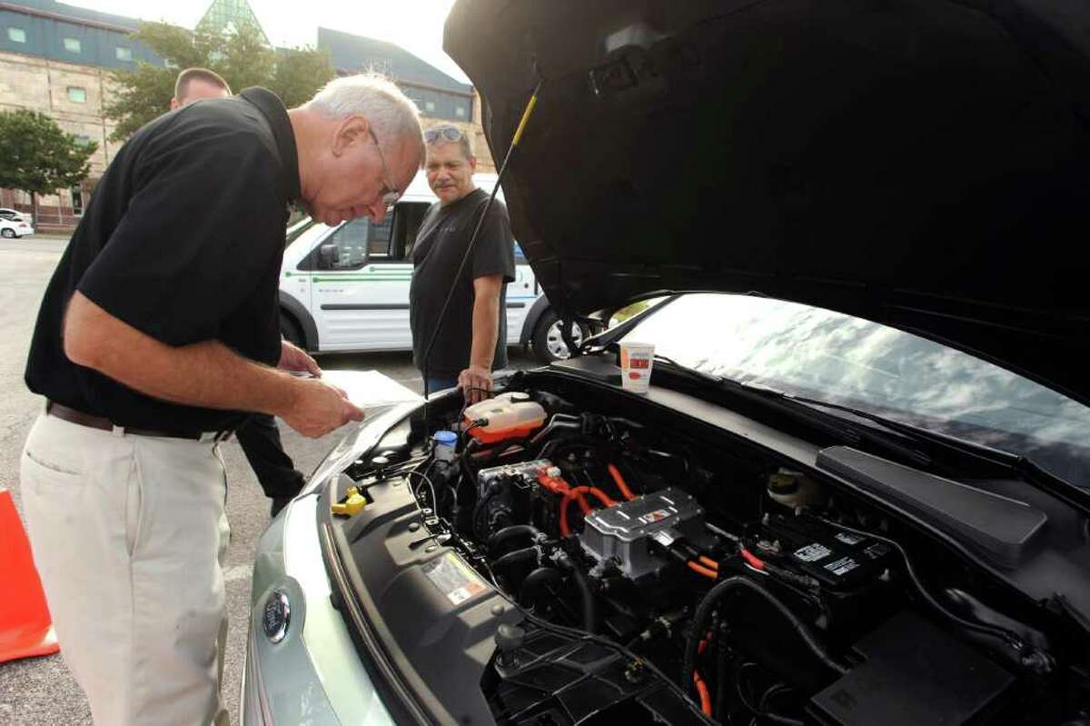 Phillip Fizzell, retired Ford engineer, examines a Ford Focus Electric which was on display, along with other Ford environmentally friendly vehicles, at the UTSA downtown campus on Tuesday, Oct. 11, 2011. The model soon will be available to the public.